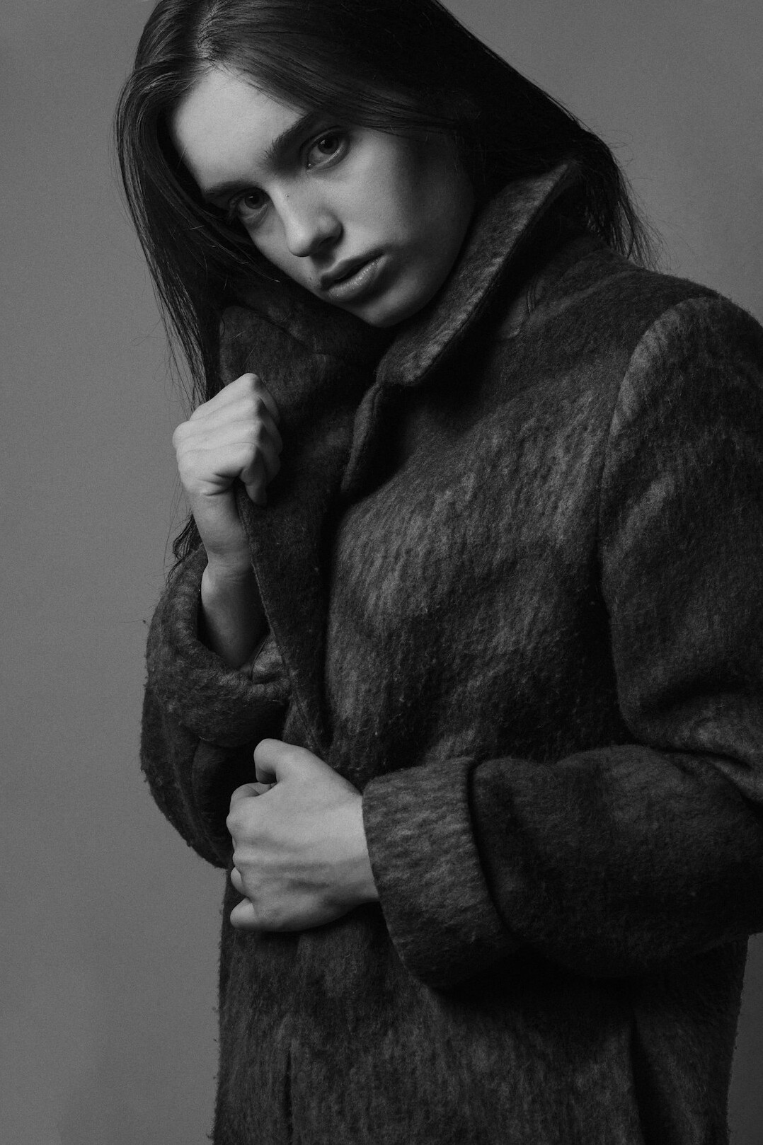 Portrait of a German woman in her forties with short dark hair in a charcoal blazer
