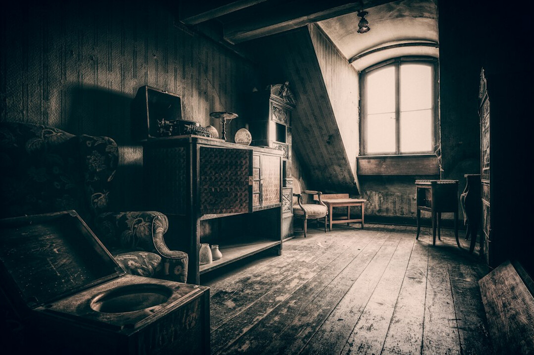 Vintage television in an empty living room with an armchair in warm light
