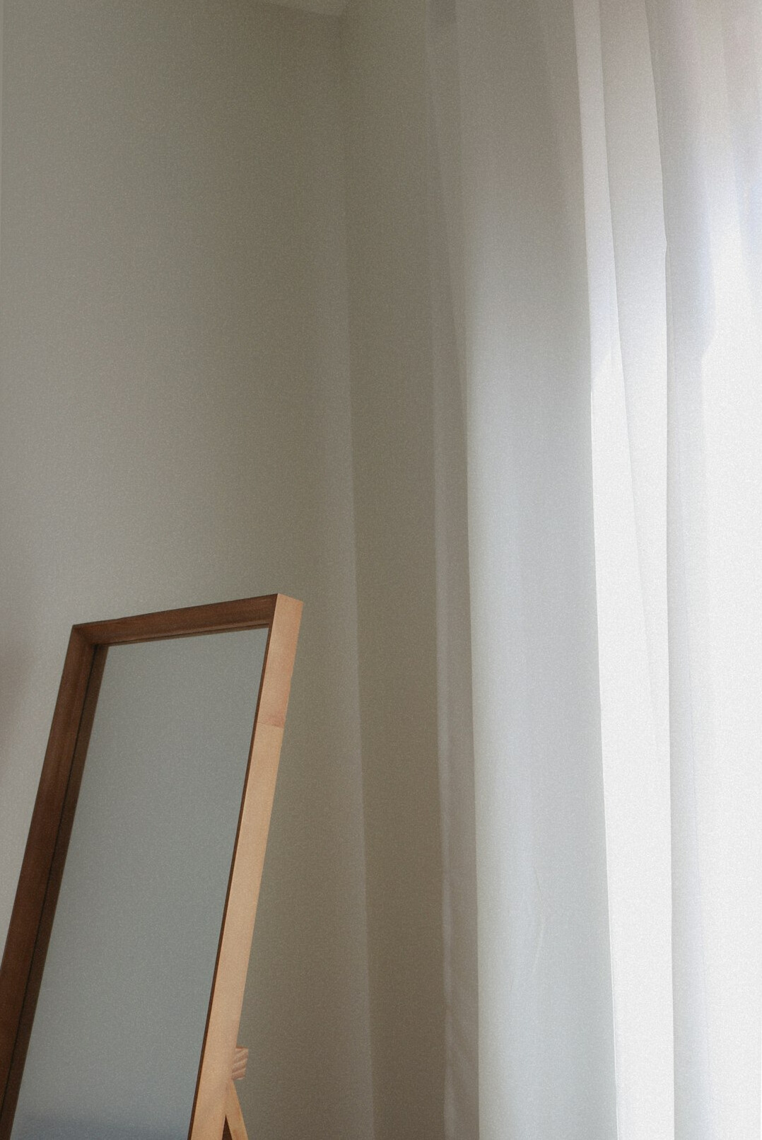 Antique mirror in a minimalist room with soft daylight